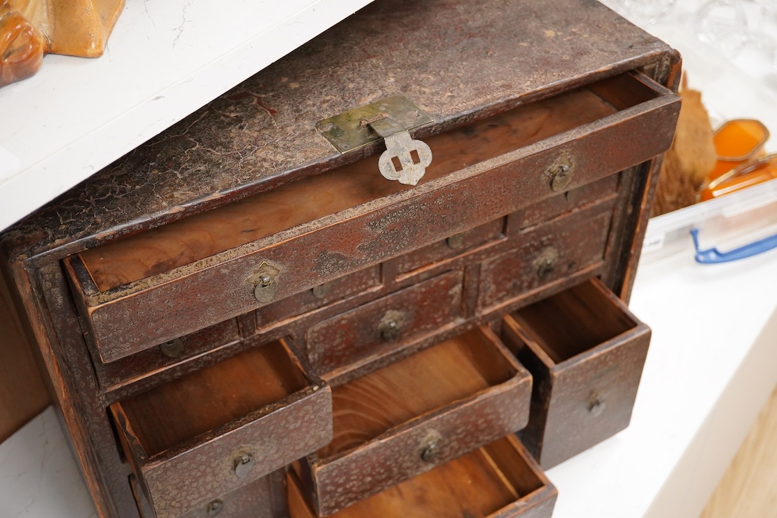 An 18th century Chinese lacquered table top cabinet, 52cm wide